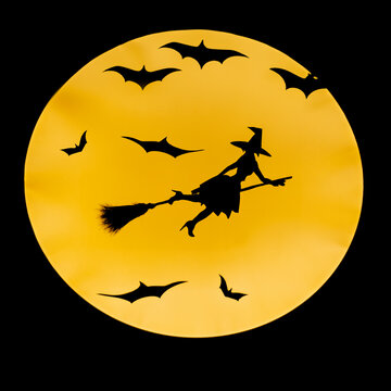 witch flying across the full moon