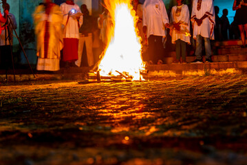 Fototapeta premium Catholic faithful are around the Santa bonfire on Saturday night hallelujah. Holy week in Valenca, Bahia.