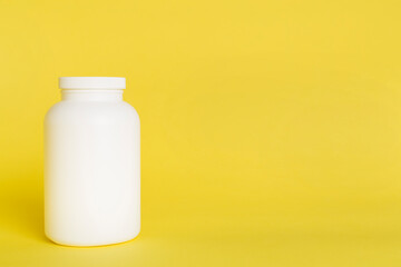 Plastic bottle for vitamins on color background