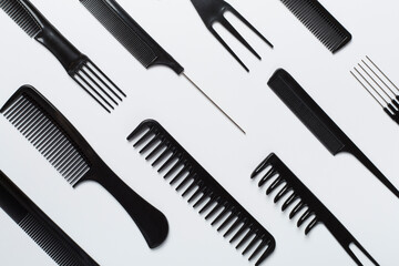 Professional combs and hairdresser tools on color background, top view