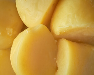 pile of boiled and peeled potatoes, tender and easily mashed or crushed cooked vegetarian food in full frame background, soft and moist textured popular ingredient in wide range of recipes