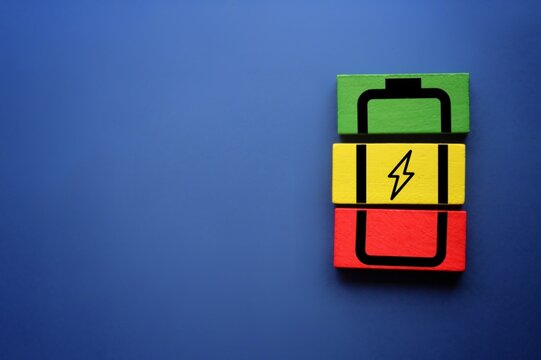 Wooden cubes with battery icon. Copy space for text. Mental health assessment, child wellness ,world mental health day, think positive, boost energy level concept