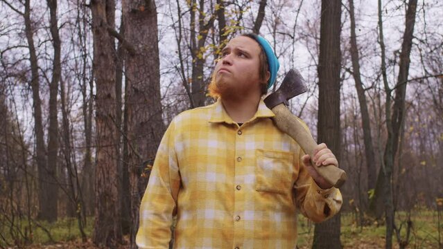 A man with axe look around and scratch beard