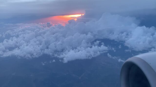 Fluffy clouds and bright sunset on the horizon