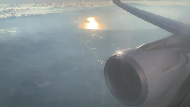 Field and lake at sunset - passenger POV from plan