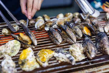 Mixed seafood barbecue on grill metal net