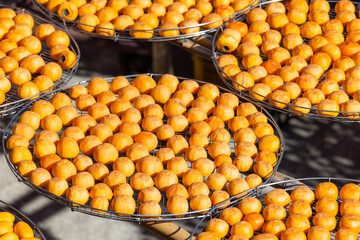Peeled persimmons drying at outdoor