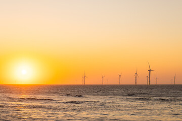Fototapeta na wymiar Wind turbine field over the sea in the evening