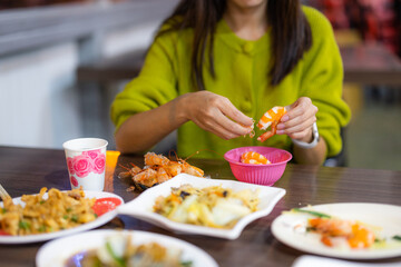 Woman peel off shrimp at restaurant