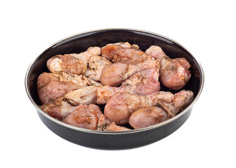 Raw chicken legs, spicy marinated drumsticks in a frying pan on a white background.