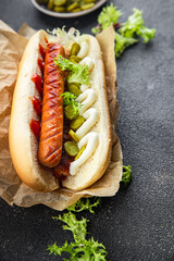 hot dog fast food sandwich sausage, gherkin, ketchup, mayonnaise meal food snack on the table copy space food background rustic top view