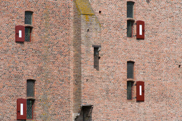 Closeup of the wall with windows of medieval castle Doornenburg in Doornenburg in the Netherlands