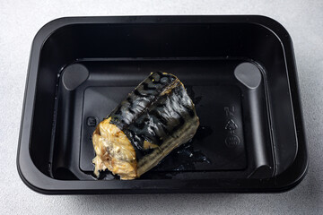 Delicious fish dishes in a black box. Delivery