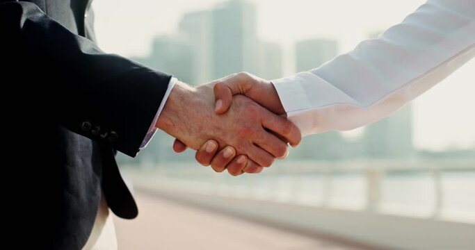 Two men in business clothes shake hands. Handshakes close-up, no face