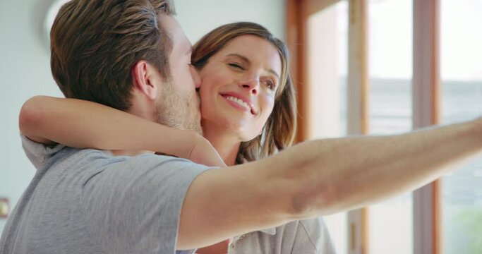 Young couple, hug and selfie in home kitchen with kiss, happiness and smile together for social network. Man, woman and happy with photography, comic profile picture and laughing on blog, app or post