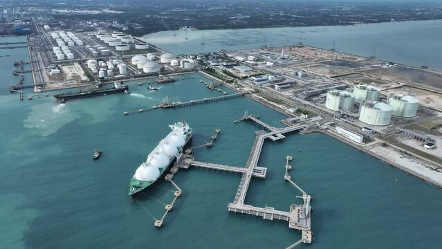 LNG (Liquified Natural Gas) tanker anchored in Gas terminal gas tanks for storage. Oil Crude Gas Tanker Ship. LPG at Tanker Bay Petroleum Chemical or Methane freighter export import transportation and