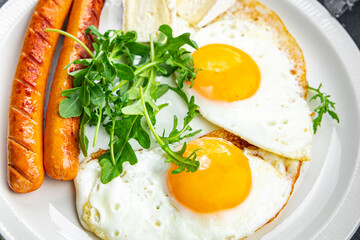 fried egg sausage breakfast green leaves lettuce arugula meal food snack on the table copy space food background rustic top view