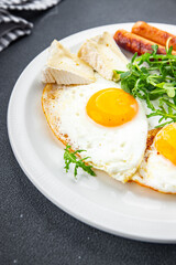 fried egg sausage breakfast green leaves lettuce arugula meal food snack on the table copy space food background rustic top view
