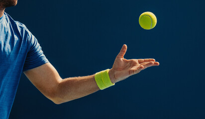 Man practicing tennis techniques with a ball