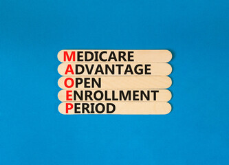 MAOEP symbol. Concept words MAOEP medicare advantage open enrollment period on wooden stick....