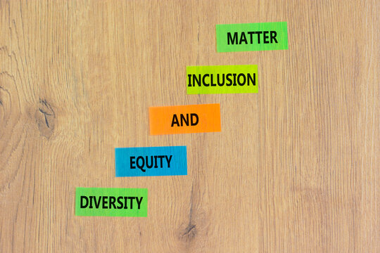 DEI Diversity equity inclusion matter symbol. Concept words DEI diversity equity and inclusion matter on colored paper. Beautiful wooden background. Business diversity equity inclusion matter concept.