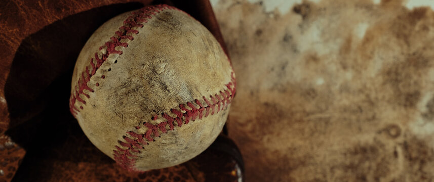 Old grunge style background with used worn baseball equipment on banner with copy space