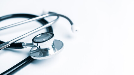 Black stethoscope on white table background with copy space. Healthcare and medical concept....