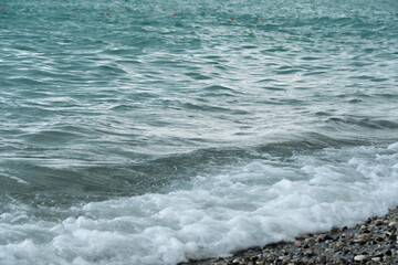 A sea wave lapping on a rocky shore