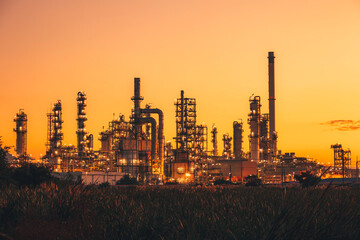 Fototapeta na wymiar Scene of the oil refinery plant of petrochemistry Oil​ refinery​ and​ plant and flue smoke industry in oil​ and​ gas​ ​industry with​ cloud​ red and orange ​sky the morning​