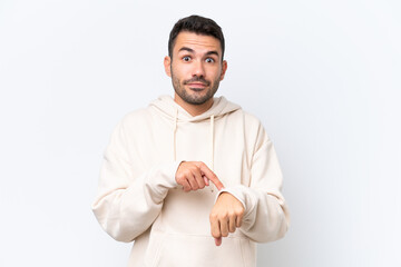 Young caucasian man isolated on white background making the gesture of being late