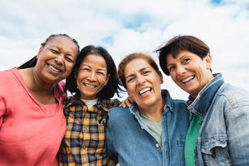 Happy multiracial senior women having fun smiling into the camera at house rooftop - 611387917