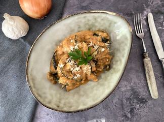 Italian art zucchini and aubergine al forno. Casserole with chicken, cream, tomatoes and parmesan.