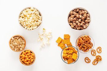 Many bowls of snacks for party - chips popcorn and nuts