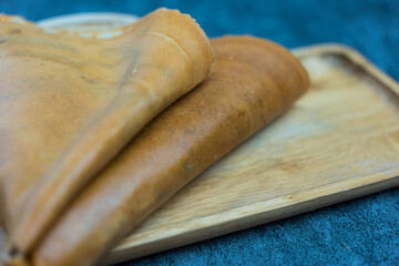 Close up of Thin crispy crepes on wood tray
