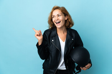 Georgian girl holding a motorcycle helmet isolated on blue background intending to realizes the solution while lifting a finger up
