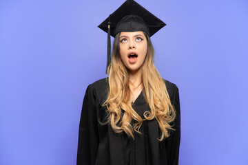 Young university graduate Russian girl isolated on white background looking up and with surprised expression