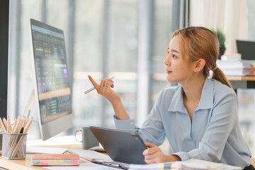 The data analyst working on a business analytics dashboard, utilizing charts and metrics to analyze...