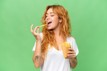 Young caucasian woman holding fried chips isolated on green screen chroma key background