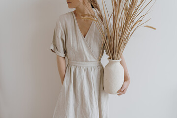 Aesthetic luxury bohemian style fashion composition. Beautiful woman in neutral tan beige linen...