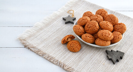 Traditional Italian almond cookies amaretti on a white background with copy space.Famous amarettini cookie biscuits.Delicious Christmas pastry popular in Italy.Selective focus.