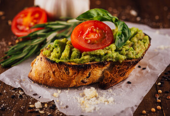 Homemade bruschetta with pesto sauce on rustic background