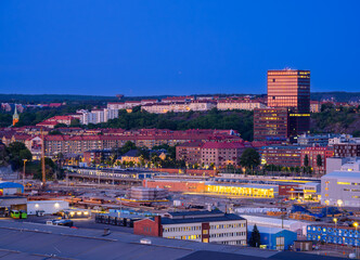Gothenburg, Sweden - May 30, 2023: Blue hour in the industrial Scandinavian city of Gothenburg, Sweden, with skyscrapers and residential apartment buildings