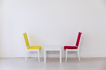 Fototapeta premium chairs yellow and red coffee table in a bright room