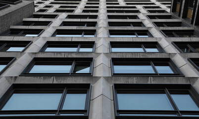 tall residential building detail (windows, lines, symmetry, asymmetry) looking up at closed and...