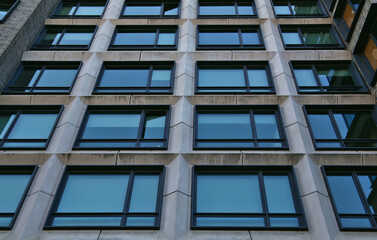 tall residential building detail (windows, lines, symmetry, asymmetry) looking up at closed and open windows, juliet balcony