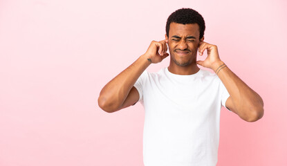 Fototapeta na wymiar African American man on copyspace pink background frustrated and covering ears