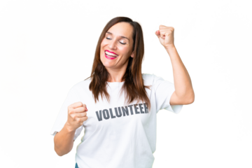 Middle age volunteer woman over isolated chroma key background celebrating a victory