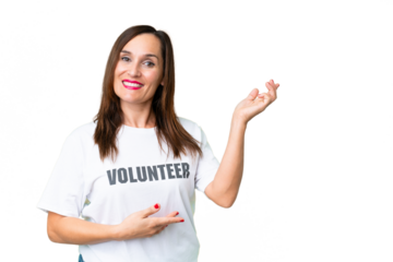 Middle age volunteer woman over isolated chroma key background extending hands to the side for inviting to come