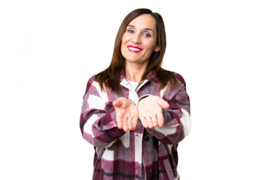 Middle age woman over isolated chroma key background holding copyspace imaginary on the palm to insert an ad