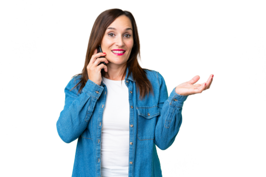 Middle age woman over isolated chroma key background keeping a conversation with the mobile phone with someone